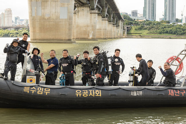 보트에서 한강 수중 정화 활동을 준비하고 있는 회원들
