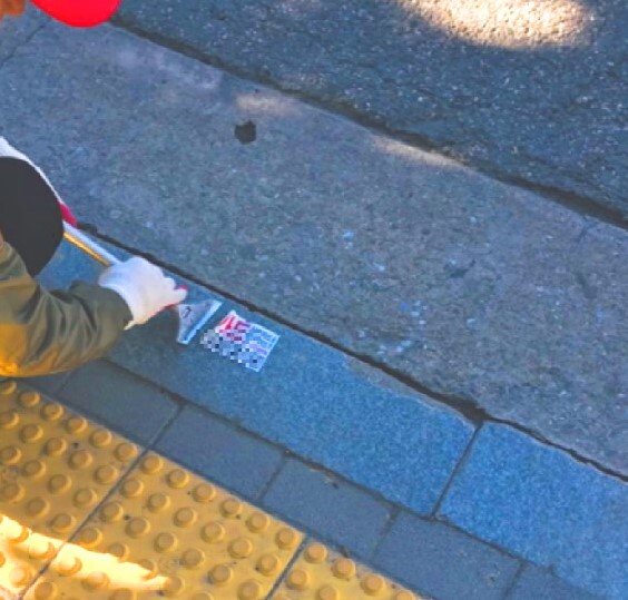 불법광고물 수거보상원이 바닥에 부착된 불법광고물을 수거하는 모습&nbsp;